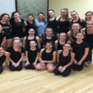 A group of girls in black leotards at a dance studio with their teacher Christina Caravella